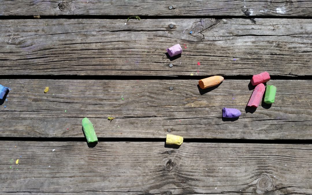 pieces of chalk on a faded wooden deck