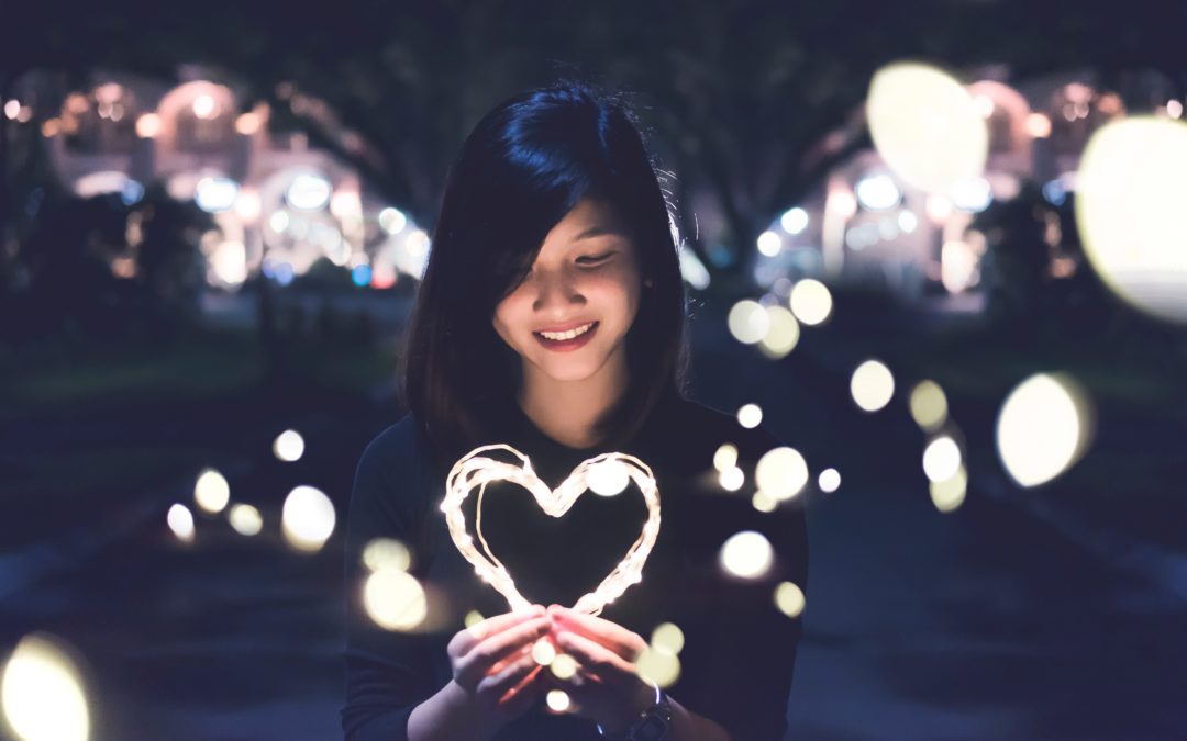 woman holding heart of light