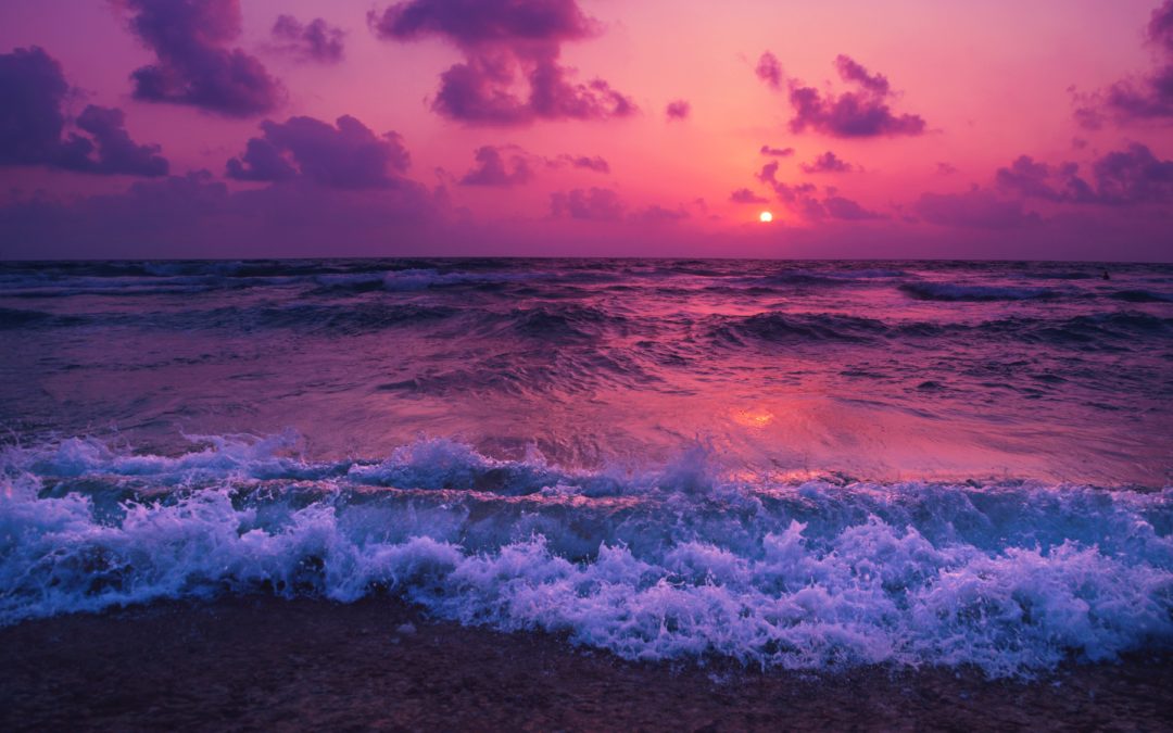 purple sunset over the ocean - releasing restrictions to manifesting