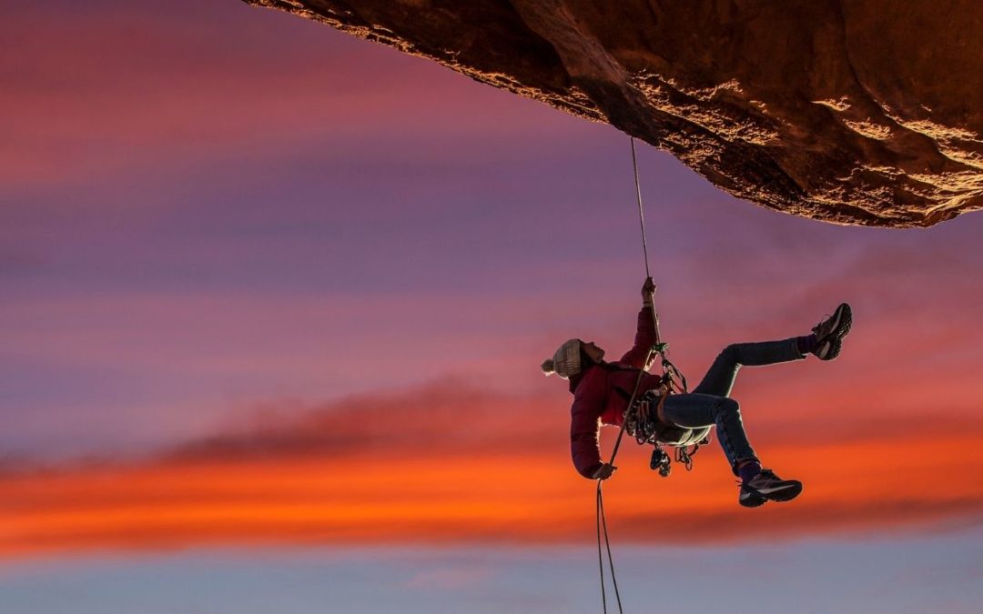 person rock climbing symbolizing fun in spite of restrictions