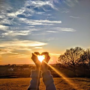 hands making heart symbolizing the need to let our emotions through