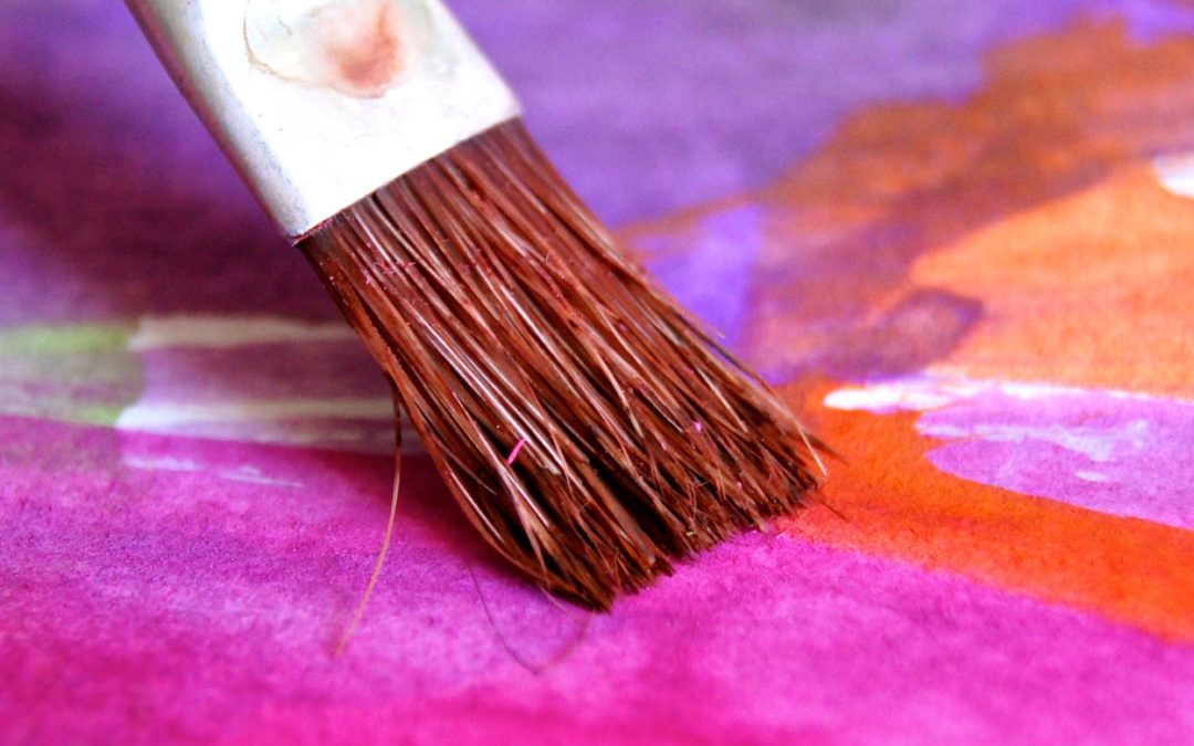 pink orange and purple watercolor paint with brush representing designing your best life now