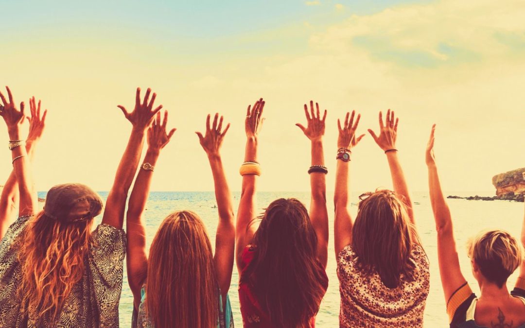 women holding up their arms to the sky representing empowering yourself